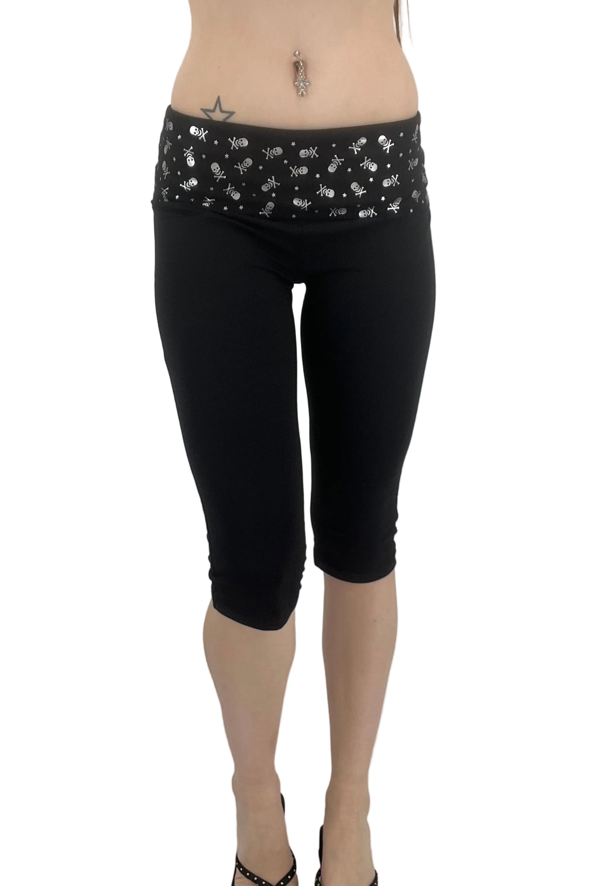 Black capri leggings with a wide waistband featuring a silver skull pattern
