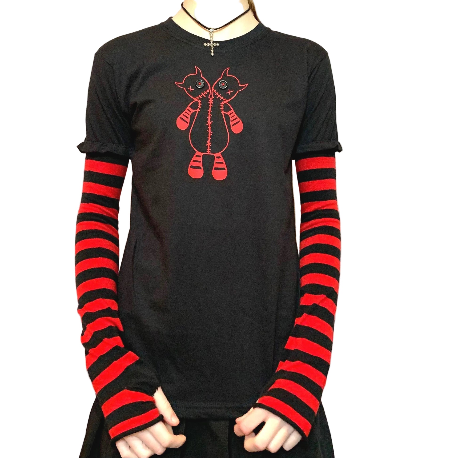 Front view of black t-shirt with red and black striped sleeves, embroidered two-headed monster with button eyes and red stitching