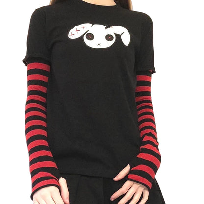 Front view of red black kawaii goth t-shirt with striped sleeves, ribbon bow, and button-eye embroidery