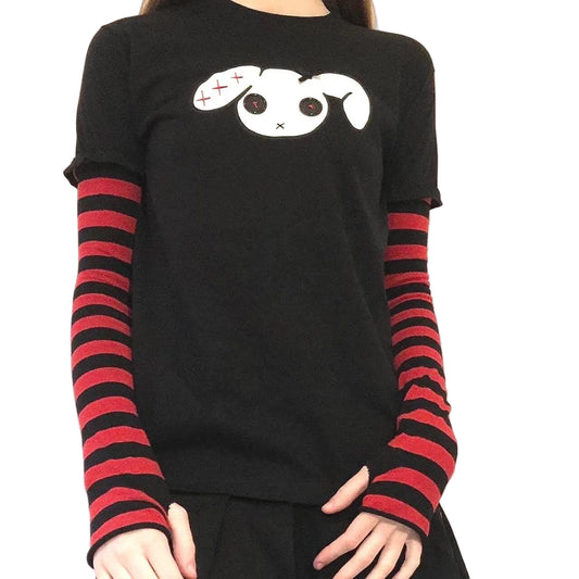 Front view of red black kawaii goth t-shirt with striped sleeves, ribbon bow, and button-eye embroidery